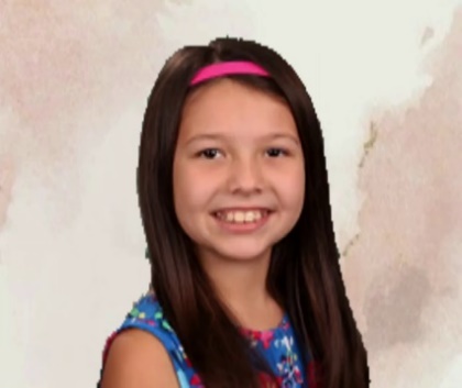A child smiling for the cameraDescription automatically generated with low confidence