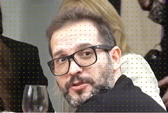 A person with glasses and beard Description automatically generated